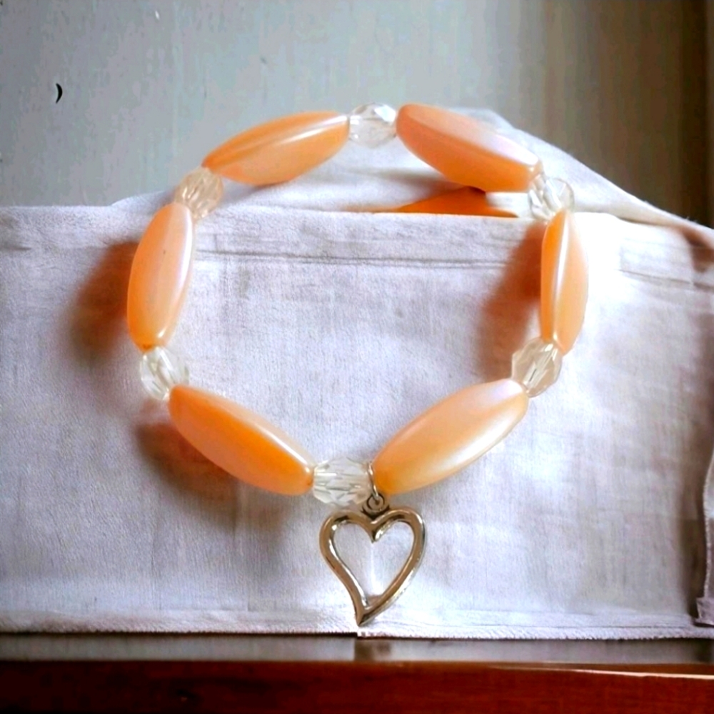 Handmade peach and clear beaded bracelet with heart charm
